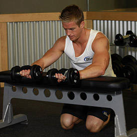 Palms-Down Dumbbell Wrist Curl Over A Bench thumbnail image