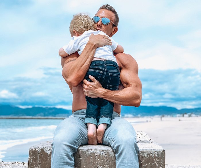 Brandan Fokken holds his son on the beach during a recent photo shoot.