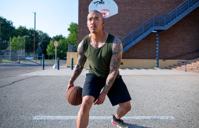Playing basketball outdoors. 