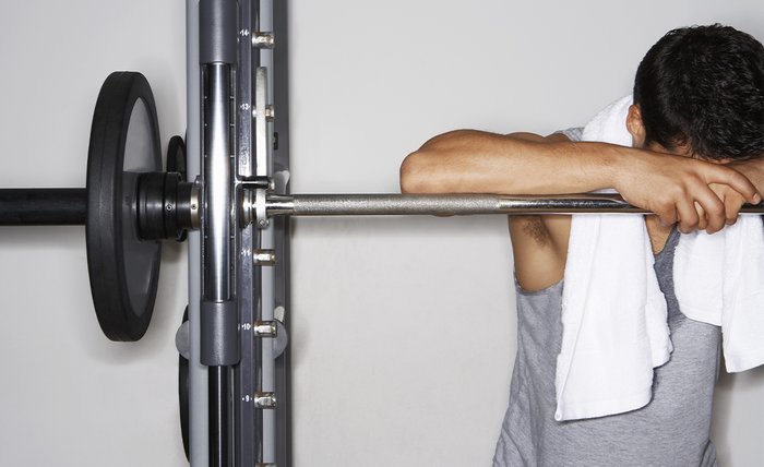 Resting against a barbell. 