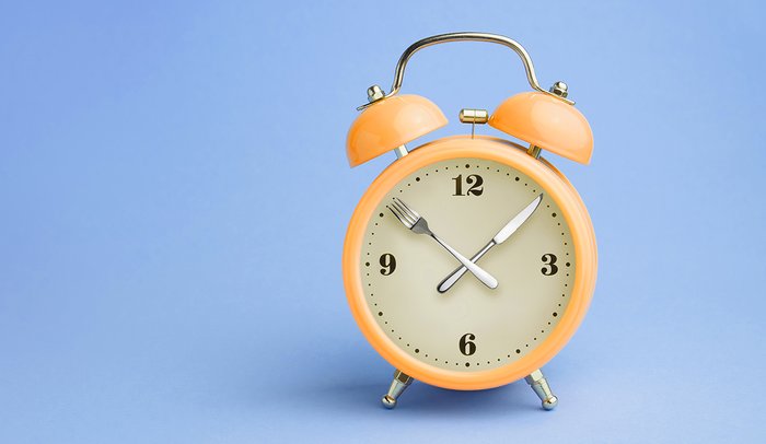 Alarm clock with knife and fork as hands. 