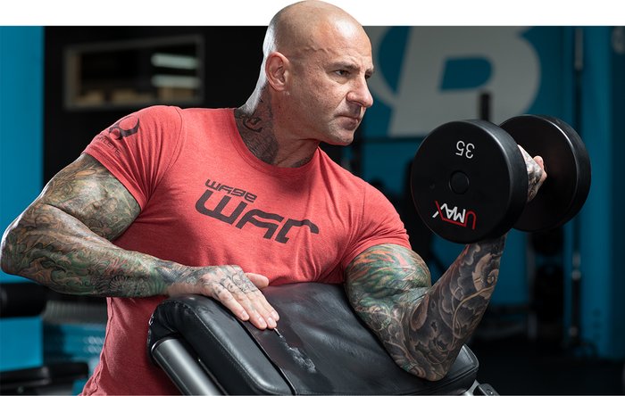 Jim Stoppani performing a Dumbbell Preacher Curl. 