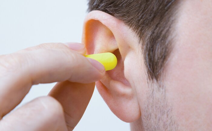 Putting in ear plugs. 