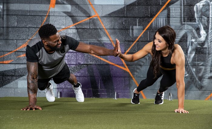 Performing push-ups with a training partner.