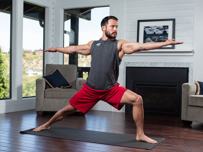 A male athlete performing yoga. 