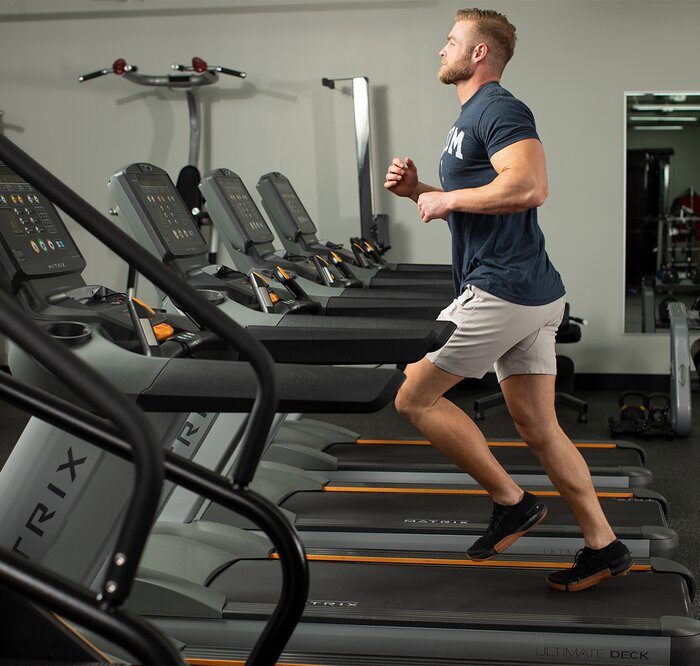 Running on a treadmill in the gym.