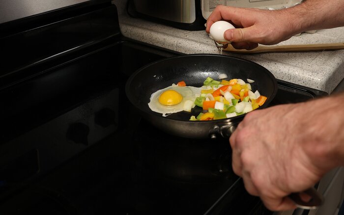 Cooking fried eggs and veggies