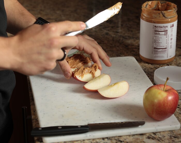 Preparing peanut butter and apples